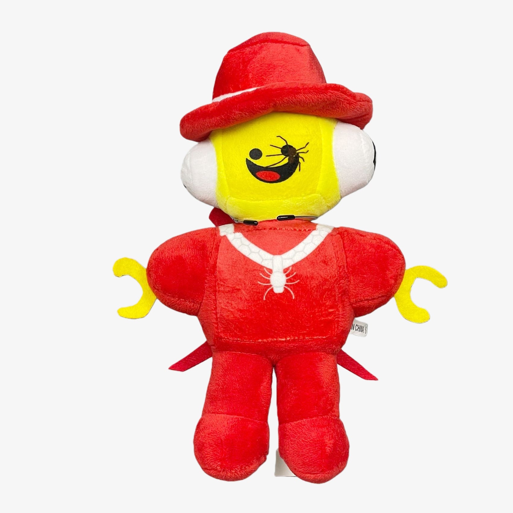 The Steal a Brainrot Red Brainrot Character Plush Toy features a yellow-faced cartoon figure with a smile, dressed in a red hat and outfit. This 10.2” collectible stuffed doll is shown against a plain white background.