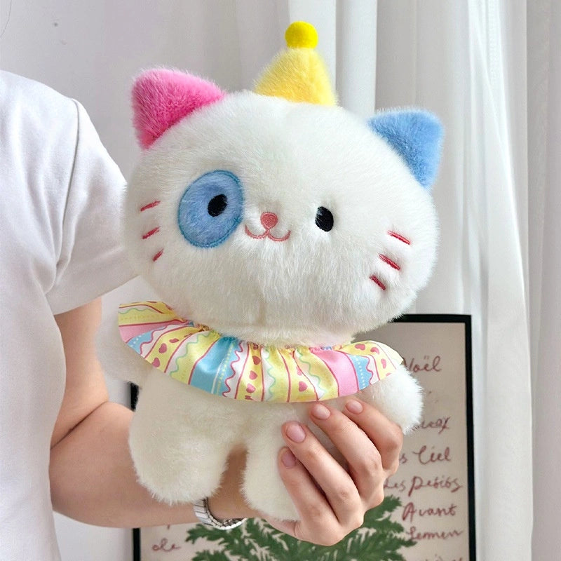 A person holds the ZoDoll Adorable 8.7" Cute Cat Plush Toy, a soft kawaii kitten plush with a pink ear, blue ear, blue eye patch, yellow party hat, and a colorful ruffled collar.