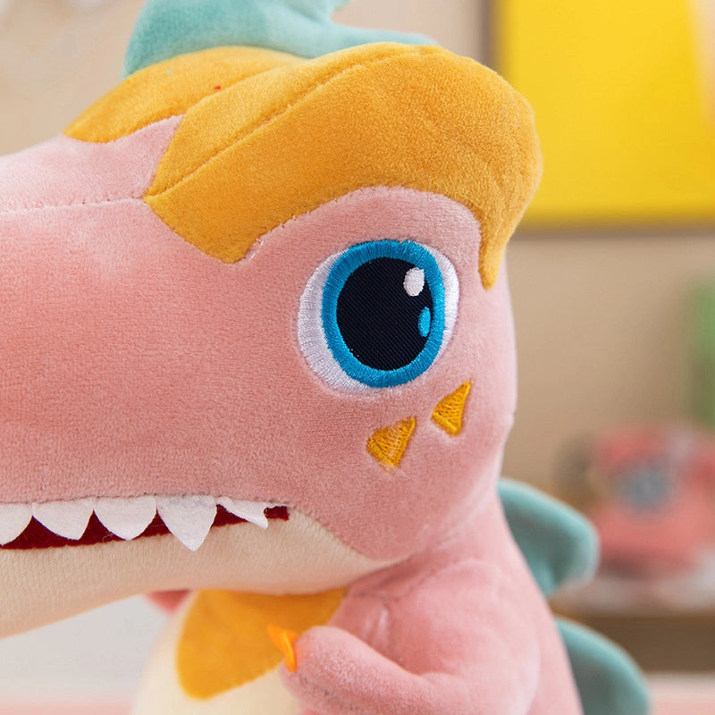 Close-up of the ZoDoll T Rex Plush Dinosaur Toy, a soft stuffed animal with blue eyes, yellow hair-like accents, white teeth, and green spikes along its back. Available in 40cm and 50cm sizes.