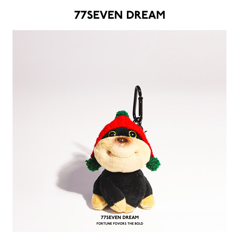 Plush dog keychain charm in red knitted hat with green pompoms