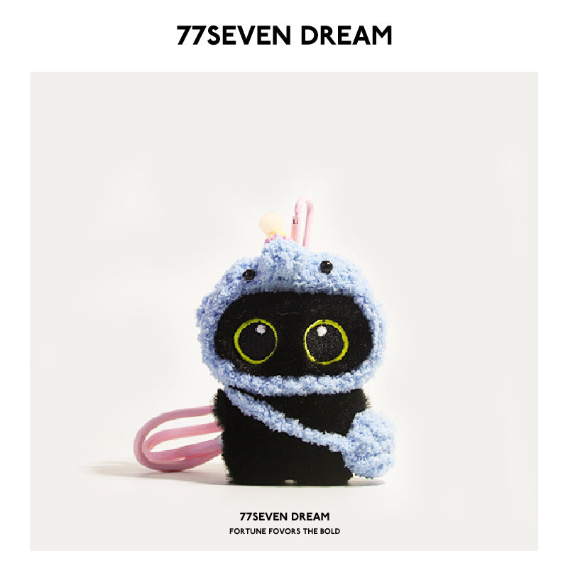 Big-eyed black cat plush charm dressed in a light blue elephant hood with pink accents