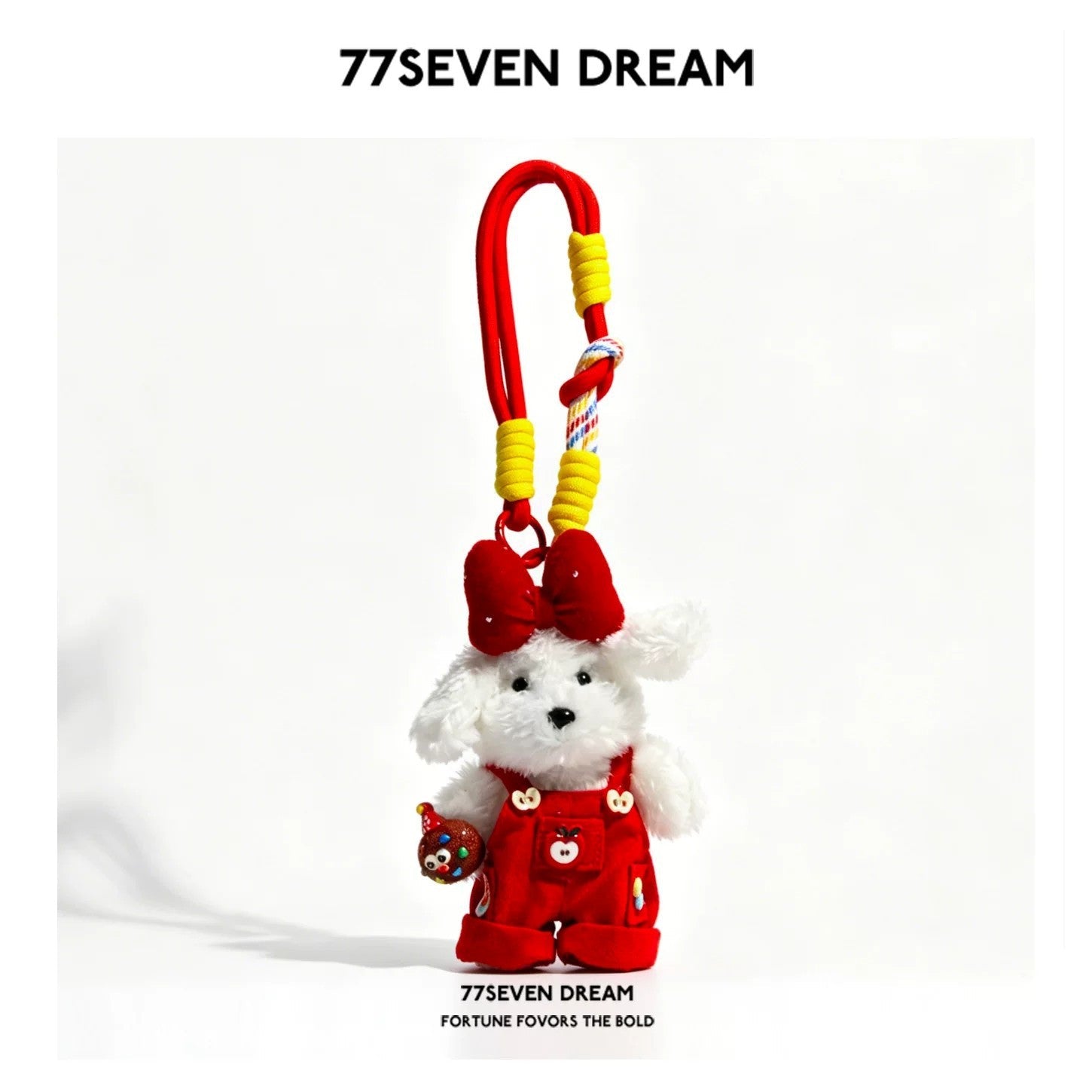 White plush dog charm in red overalls with red head bow and red knotted cord lanyard