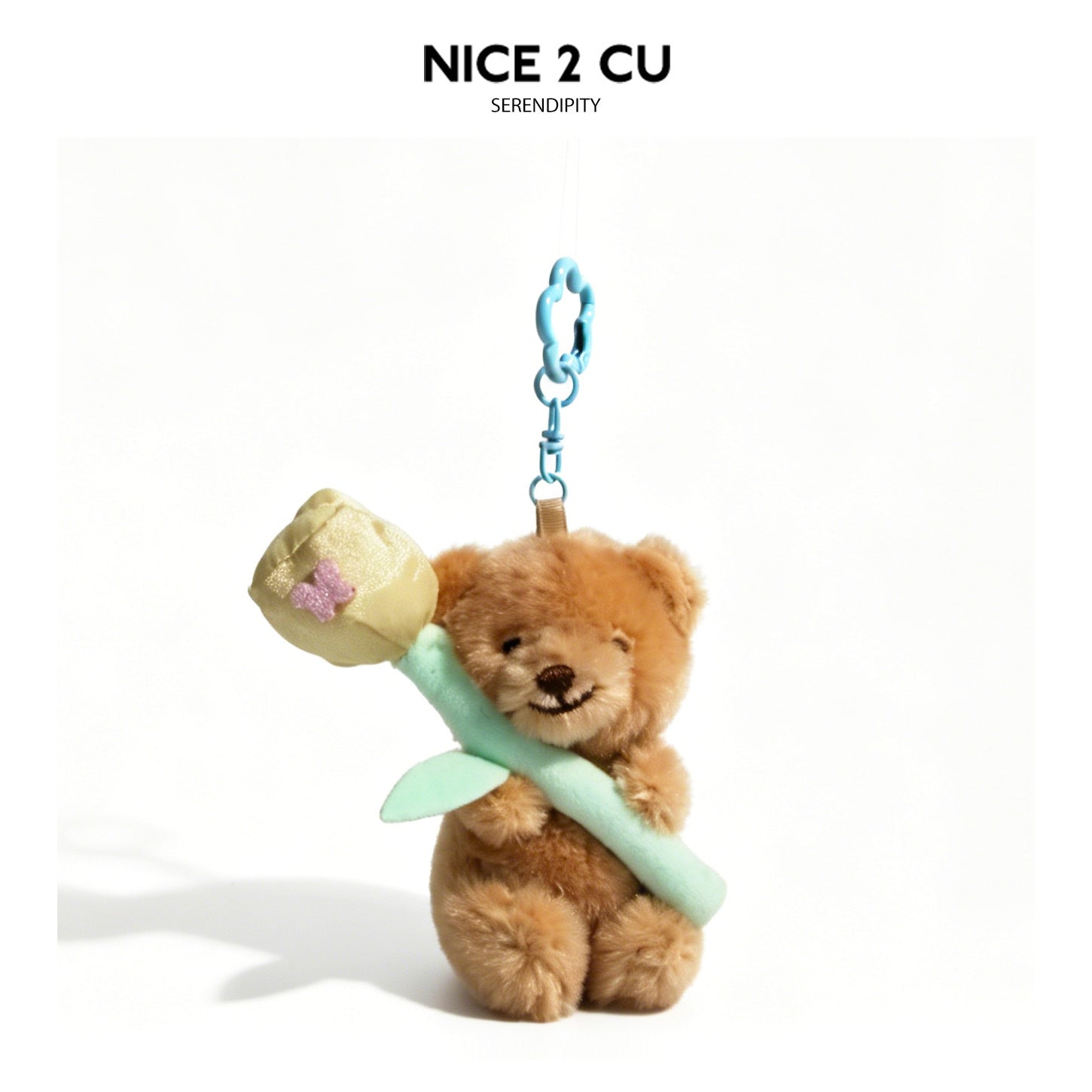 Brown plush teddy bear charm holding a flower bouquet with mint-green ribbon accent and pink flower-shaped clip