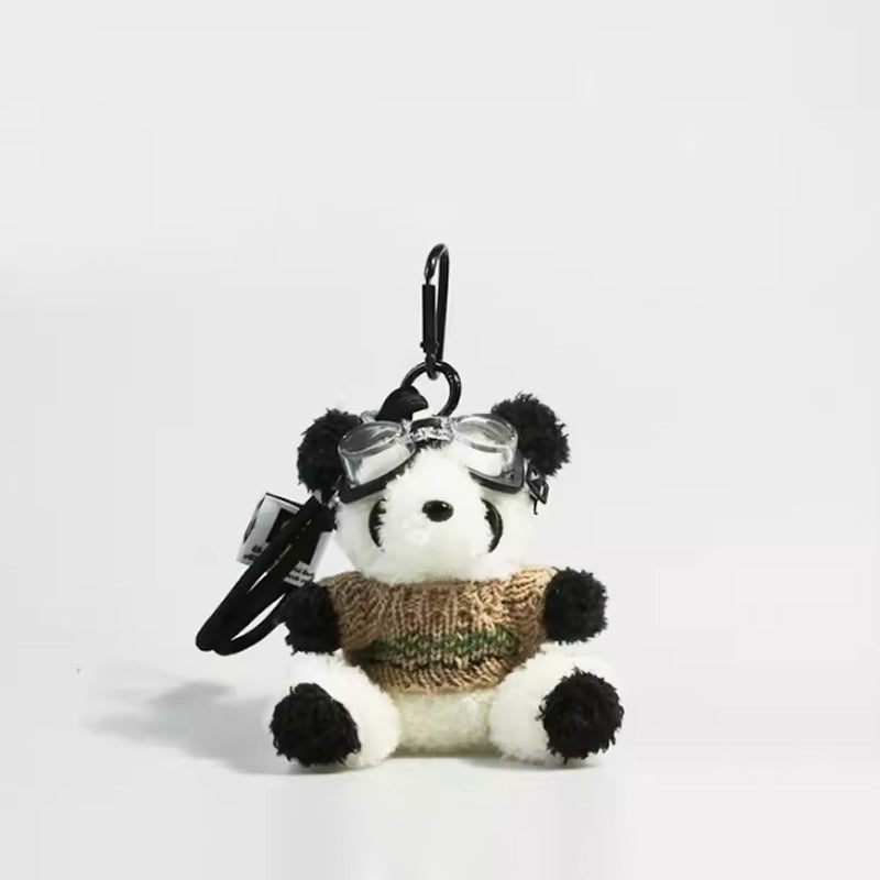 Panda plush charm with clear goggles and khaki knitted sweater attached to carabiner clip