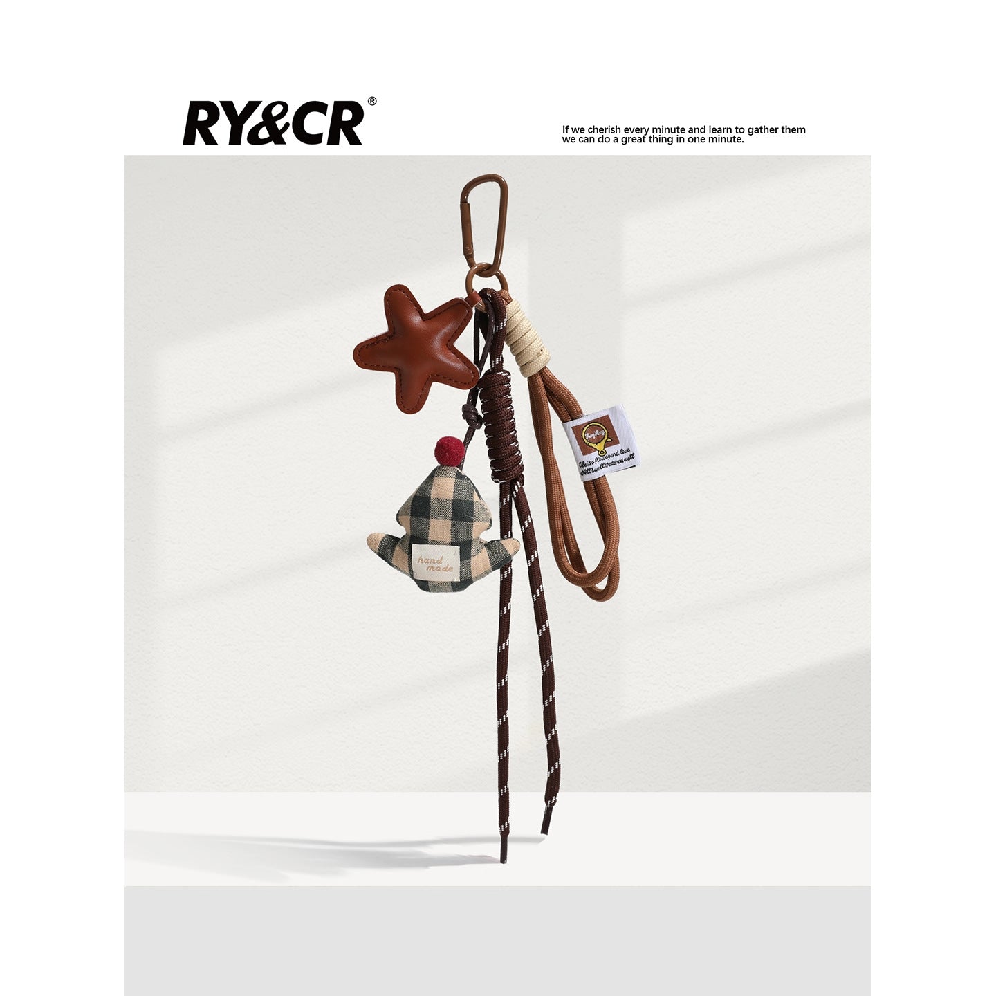 Green and cream plaid plush Christmas tree charm with red pom-pom on brown braided lanyard and carabiner clip