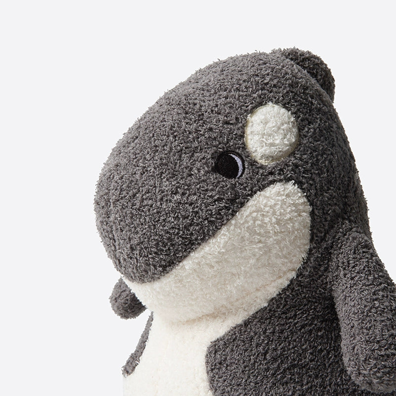A close-up of the ZEIO Orca Plush Toy 30cm—a soft, cuddly killer whale stuffed animal with a black and white textured surface and simple stitched features—set against a plain background.