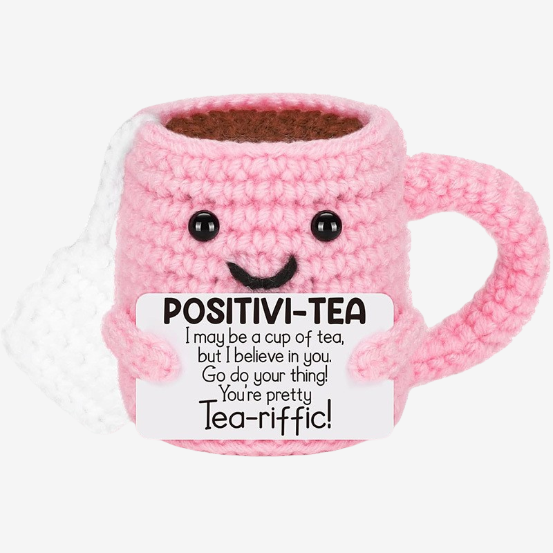 The ZoDoll Positivi-Tea Crochet Mug is an uplifting pink amigurumi with a smiling face and encouraging sign—a perfect daily gift for tea lovers who need positivity and cheer!.