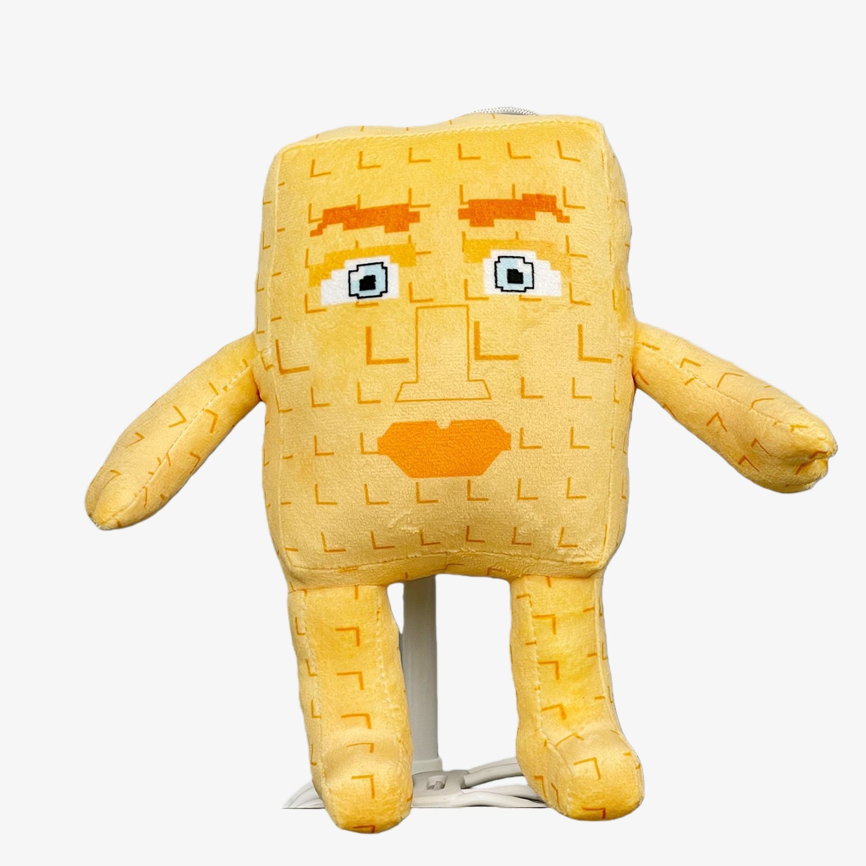 The Steal a Brainrot Inspired Beige Square Character Plush Toy is a 9.1-inch minimalist humanoid plush with a pixel face, arms, and legs—perfect as a collectible for fans of pixel art and soft stuffed cartoon figures.