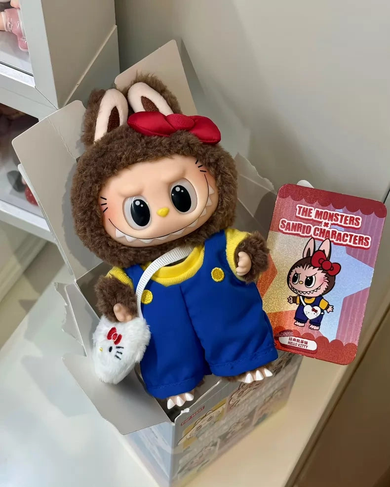 The POP MART LABUBU Hello Kitty and Friends Series Secret Edition Plush Pendant Figure features large eyes, blue overalls, and a brown bunny hoodie with ears and red bow—ideal for Sanrio fans and comes with a The Monsters card in an open box.