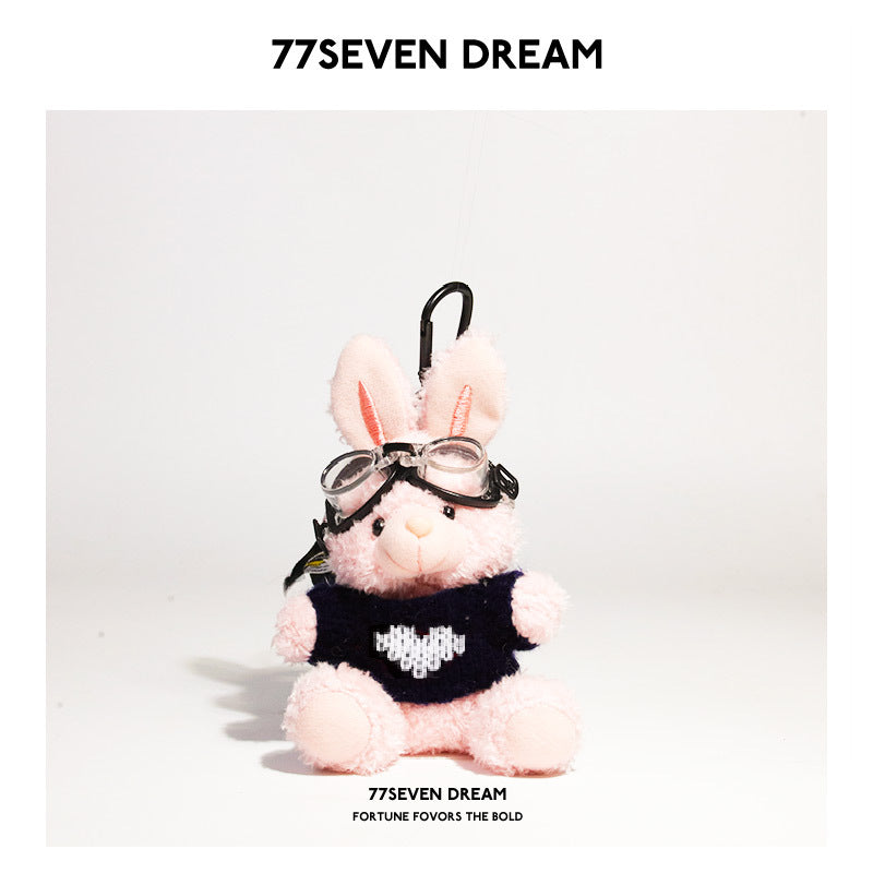 Pink rabbit plush keychain wearing black heart-pattern knit sweater and goggles with black hanging clip