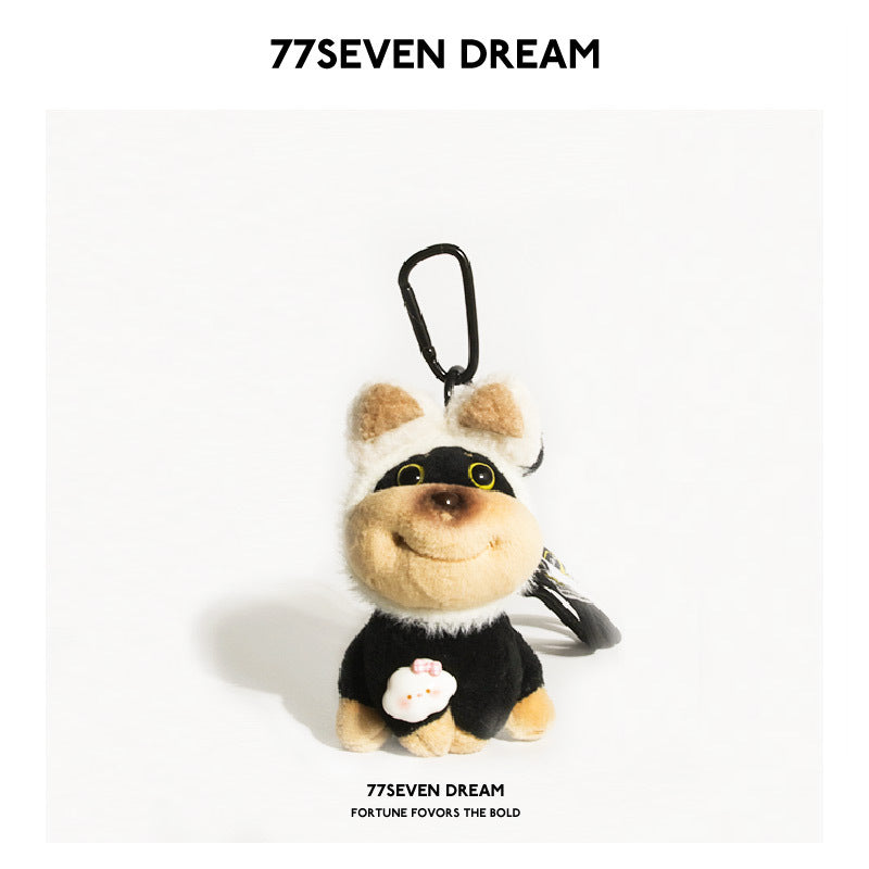 77SEVEN DREAM Bee Dog plush keychain with beige round ears, black-and-tan body, and flower chest detail on white background