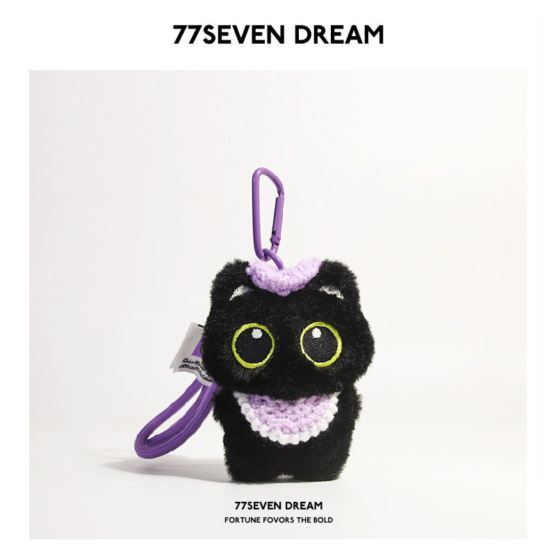 Black cat plush charm with green-outlined eyes and purple crocheted bib, purple carabiner clip