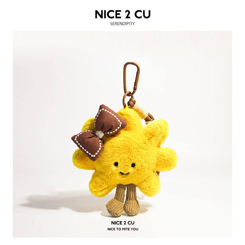 Yellow sunflower plush charm decorated with a brown bow and brown-toned clip