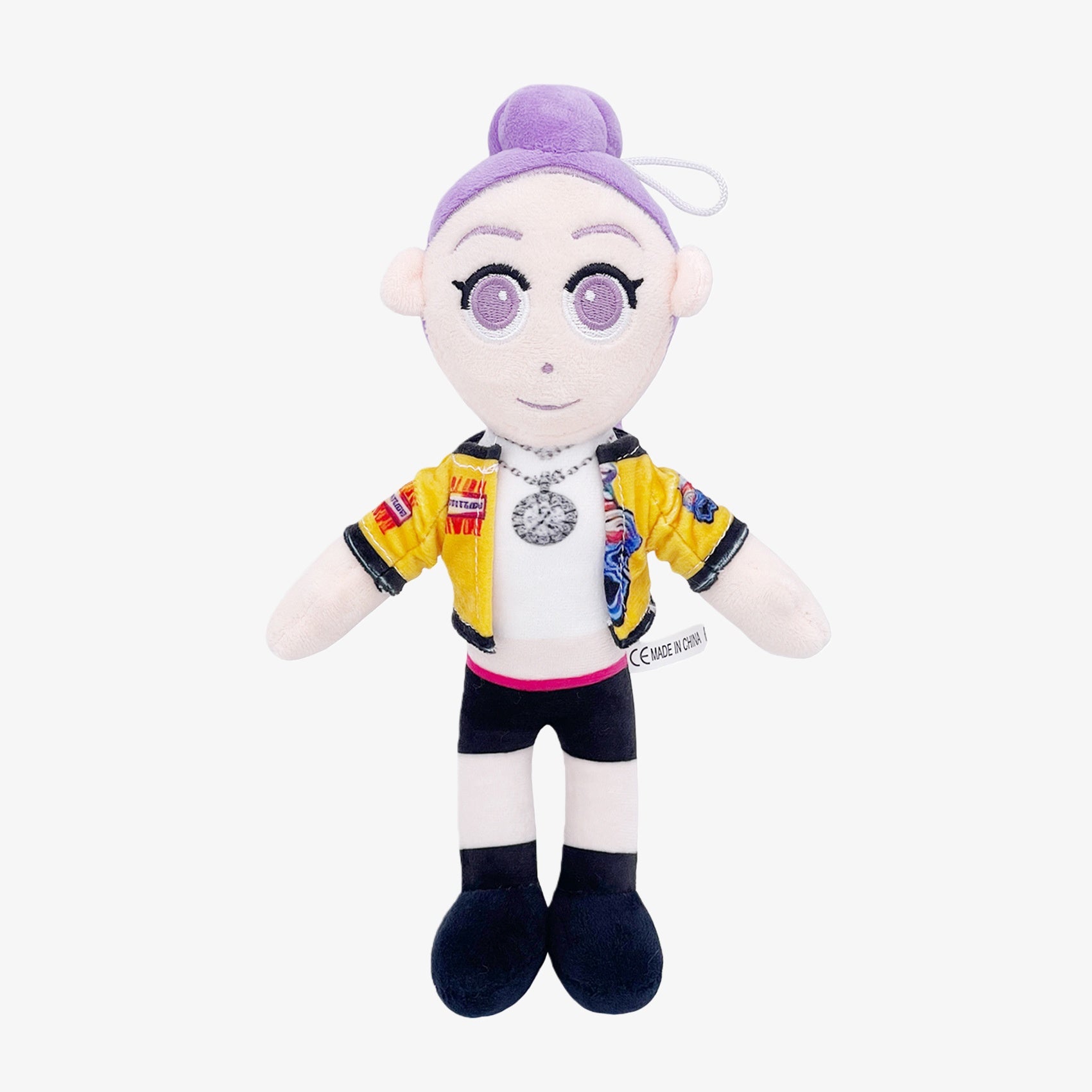 The Demon Hunters Inspired Plush Doll is a 10.6-inch anime-style female character with a purple hair bun, yellow jacket, and necklace—perfect for any collectible anime plush collection.