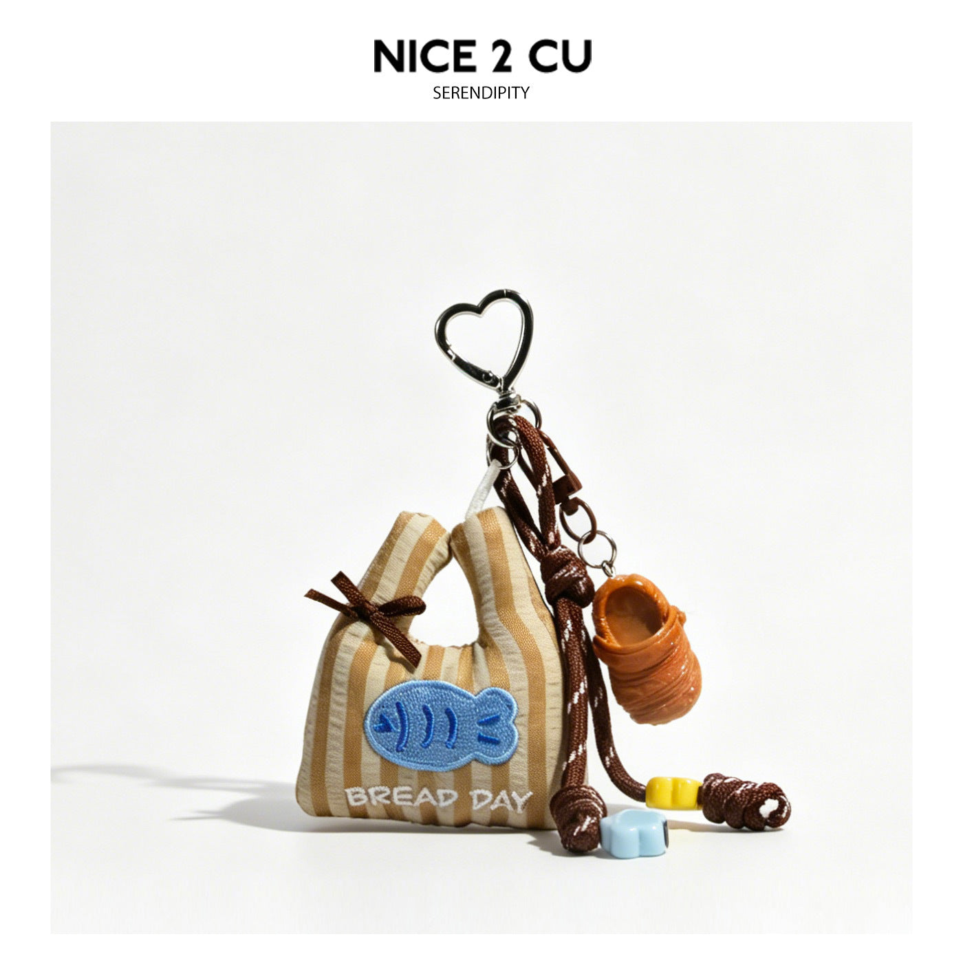 Brown striped mini bag charm with blue fish applique and BREAD DAY text, slipper pendant, and silver heart clip keychain