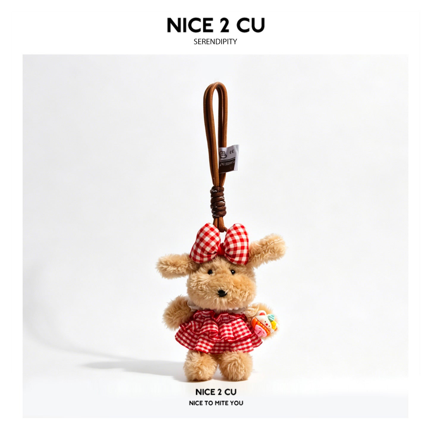 Light tan plush dog charm wearing red and white gingham ruffled skirt and bow, holding a miniature cake, with braided brown c