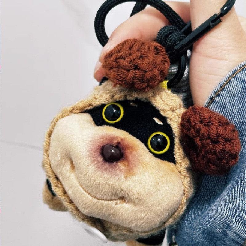 Small plush dog charm wearing plush brown bear ears