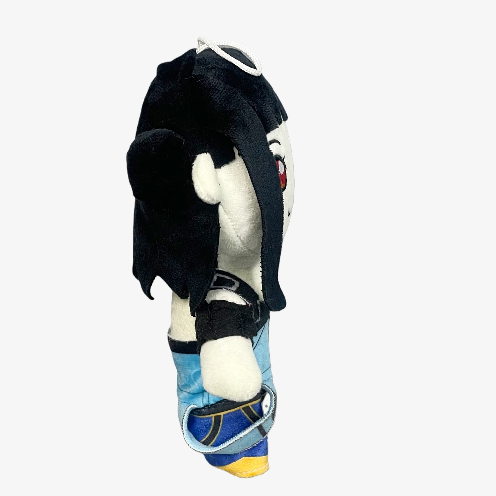 The Demon Hunters Anime Plush Doll, an 8-inch black-haired, red-eyed female character with a hanging loop, is shown in side view against a plain white background.