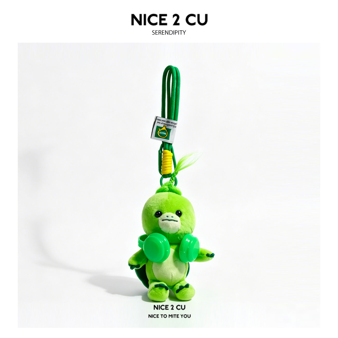 Green turtle plush keychain charm with small headphone-style chest accessory and hanging cord loop