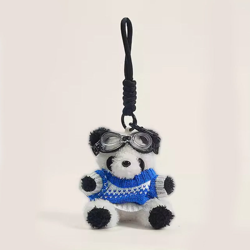 Panda plush charm with blue houndstooth-pattern loose sweater and black goggles on braided cord strap