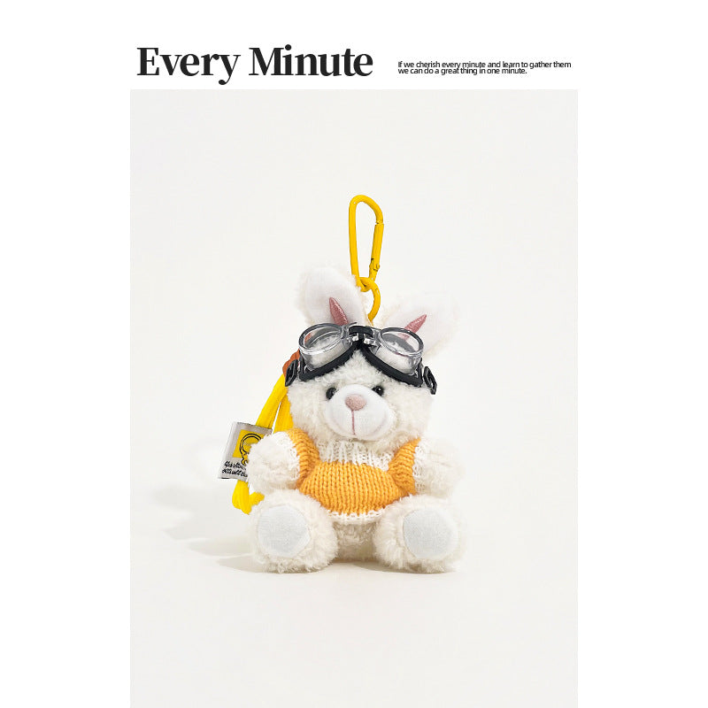 White rabbit plush keychain charm wearing aviator goggles and a yellow-and-white knit sweater with yellow carabiner clip