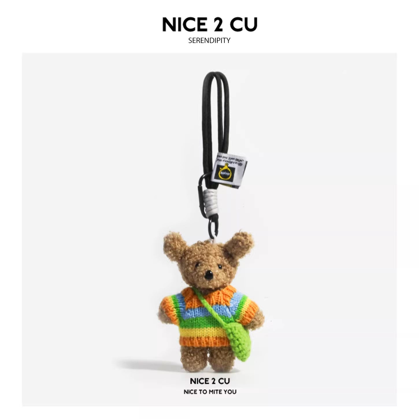 Teddy bear plush charm in rainbow striped sweater holding a green mini crocheted crossbody bag on black cord