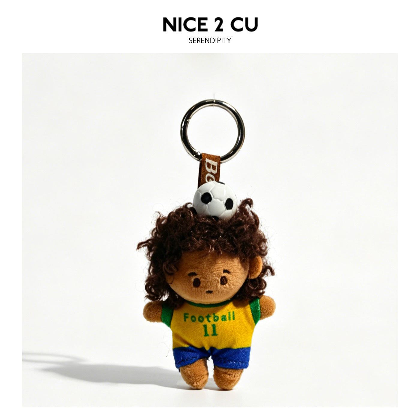Curly-haired soccer kid plush keychain wearing yellow and green Football 11 jersey with mini soccer ball on head