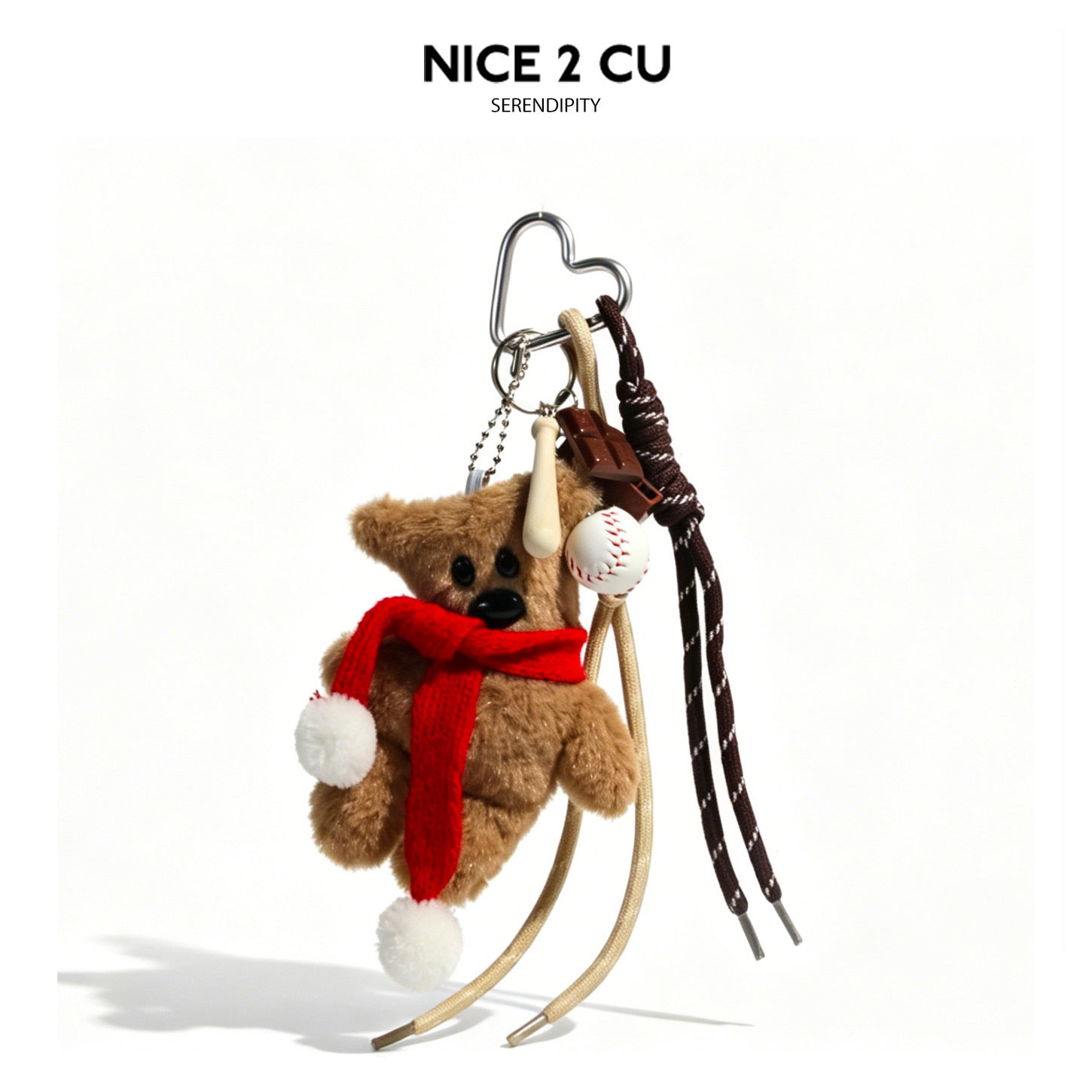 Brown plush bear keychain charm with bright red knitted scarf, white pom-poms, and dangling baseball charms on silver heart c