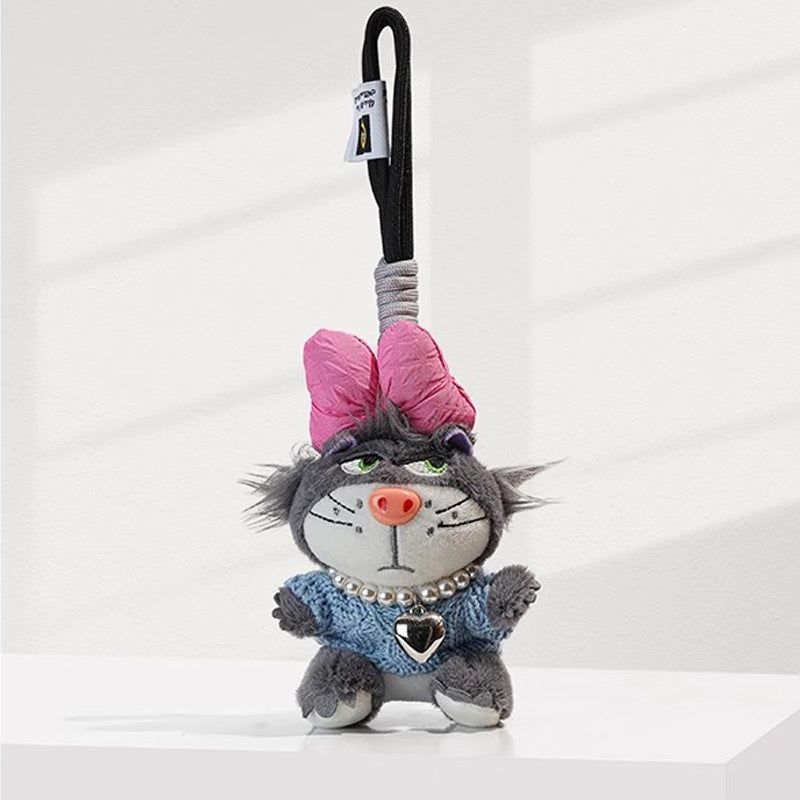 Grey grumpy cat plush charm wearing blue knit top, pink bow, and pearl bead necklace with silver heart pendant