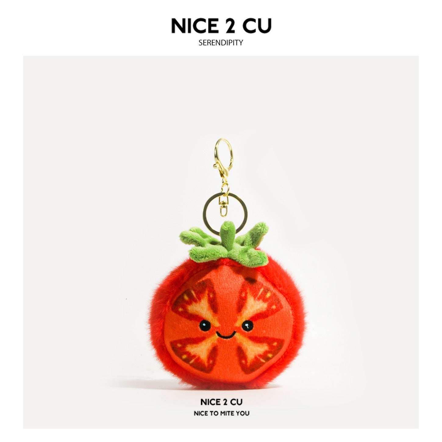 Kawaii tomato plush keychain charm with smiling face, cross-section front panel, green calyx, and gold-tone lobster clasp