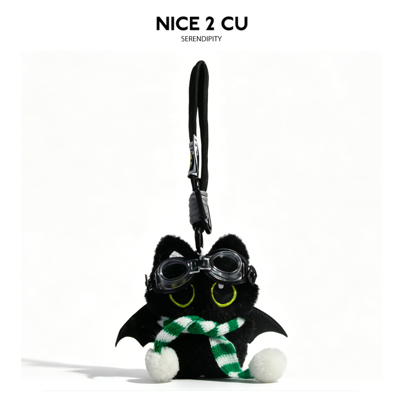 Black cat plush charm with bat wings, goggles, and green-and-white striped scarf on braided cord loop