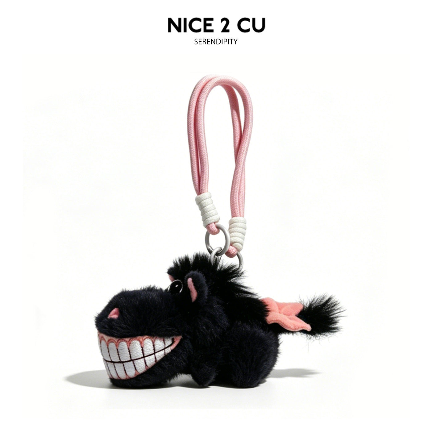 Small black fluffy plush horse charm with oversized embroidered grinning teeth, pink accent appendages, and pink braided cord
