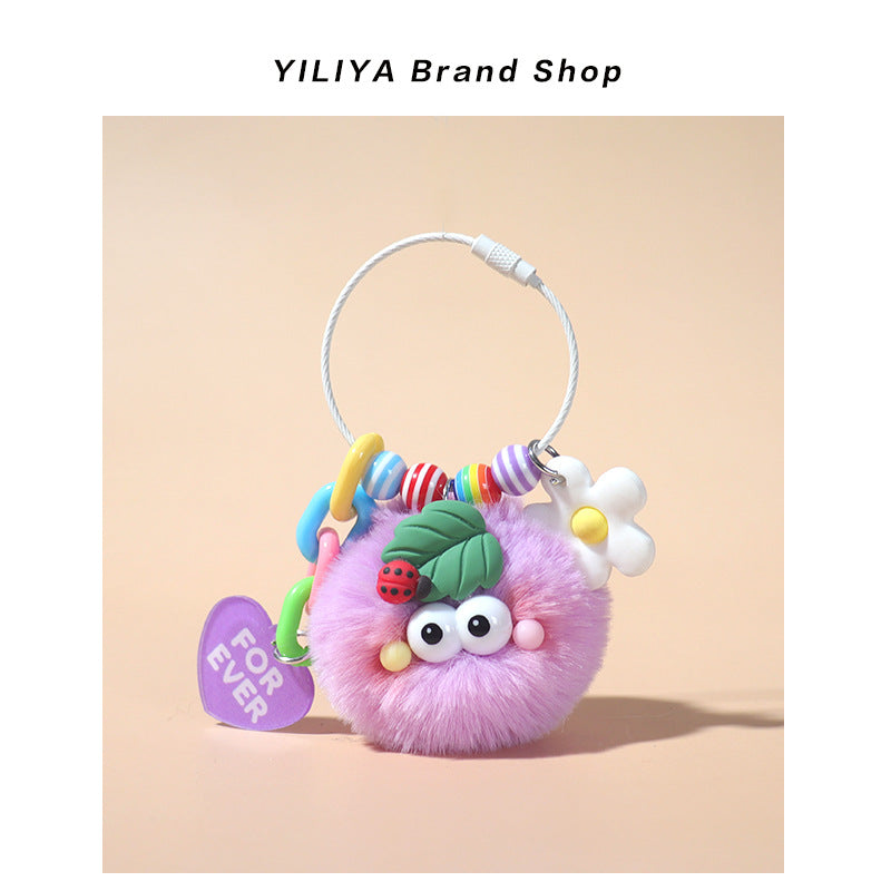 Purple fluffy pom-pom keychain charm with rainbow beads, ladybug leaf topper, and purple FOR EVER heart tag on large round ri