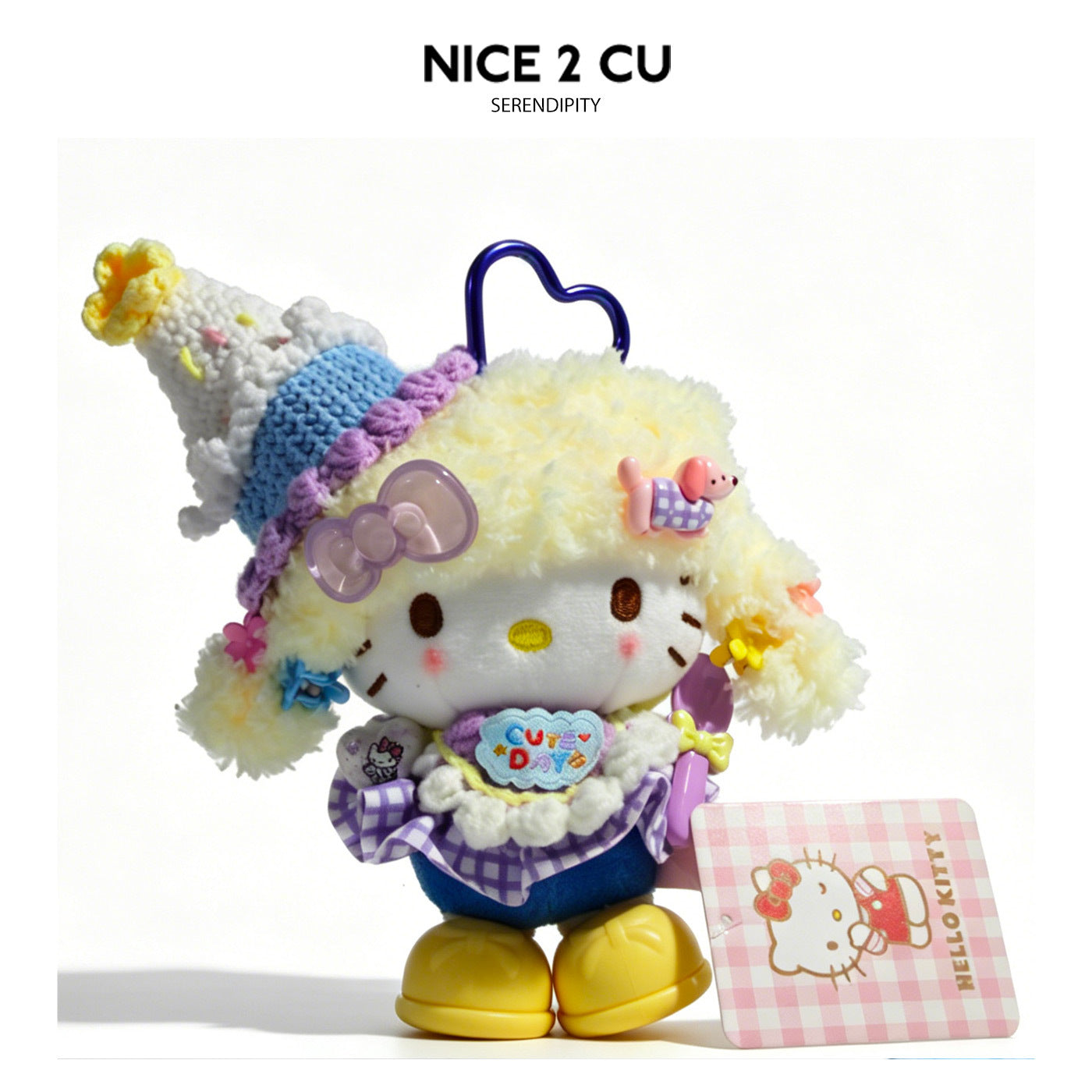 Hello Kitty plush charm with pale yellow fuzzy hair, tall cone hat, lavender outfit details, and blue heart carabiner clip