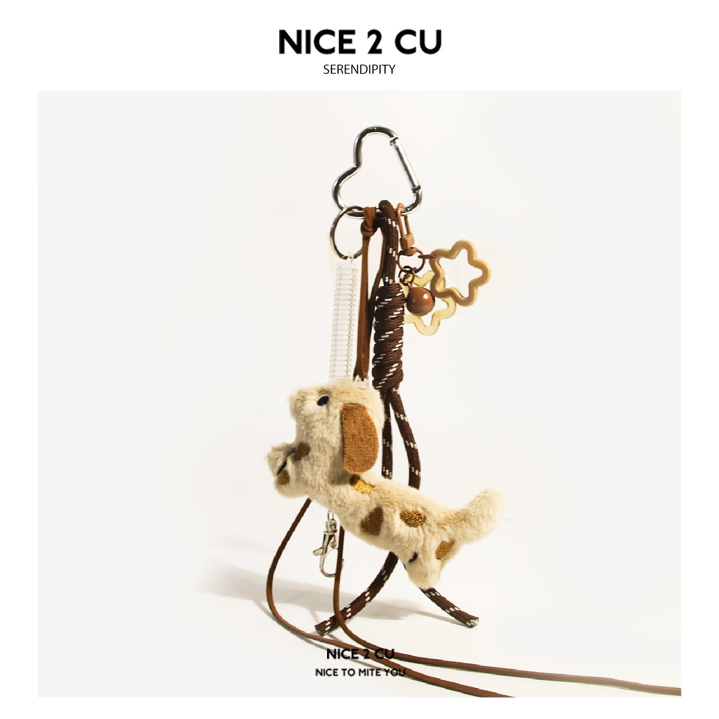 Cream spotted plush dog with brown ears and two star charms on brown cords with silver heart clasp