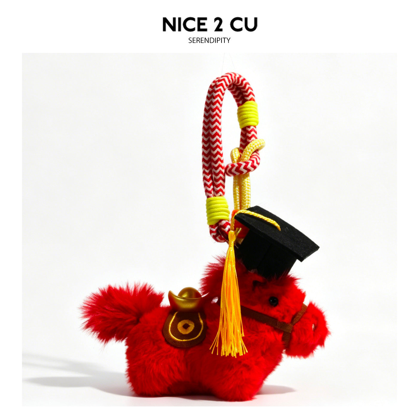 Red plush horse charm with black graduation cap, brown bridle, and red-and-yellow braided hanging rope