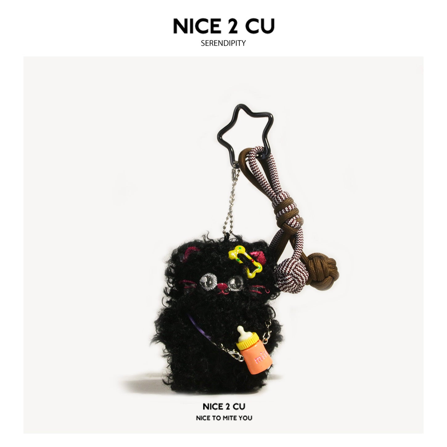 Black fluffy plush cat charm with star-shaped metal ring, knotted paracord cord, and small orange bottle charm