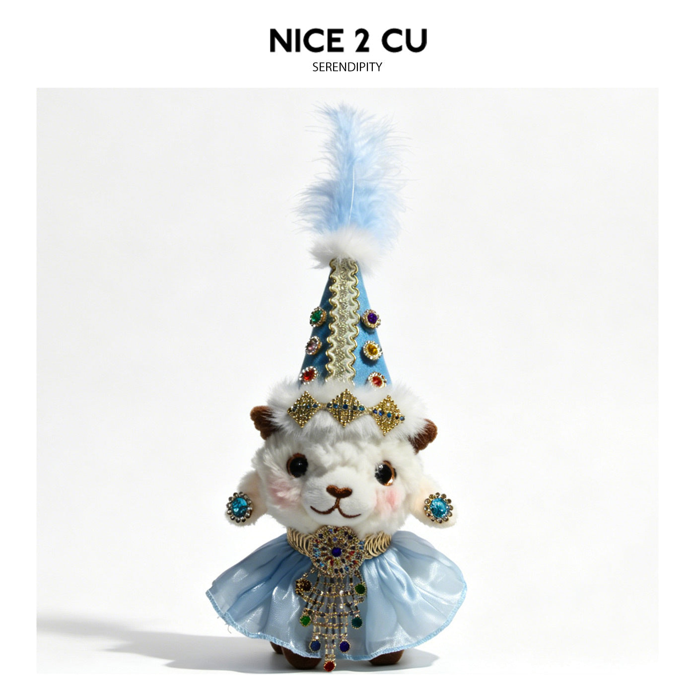 White plush lamb in sky-blue cone hat with matching feather plume, blue jewel accents, and flowing pale blue chiffon skirt