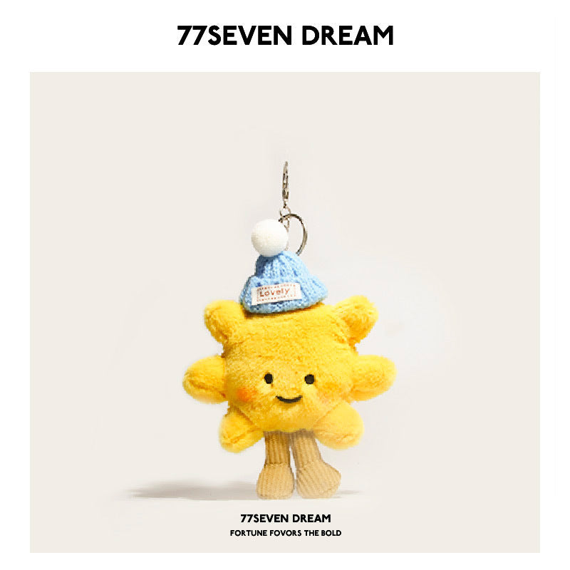 Yellow sunflower plush charm wearing a light blue knit hat with white pom-pom and clip