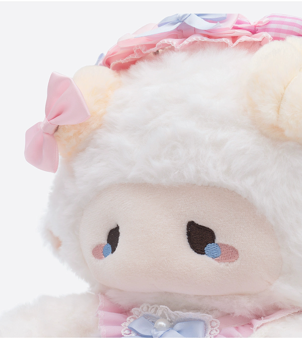 Close-up of ZEIO's Fashion Sheep Plush Toy 29cm—a cute, collectible lamb doll with fluffy white fur, pastel pink and blue bows, embroidered eyes with teardrop details, and adorable accessories.