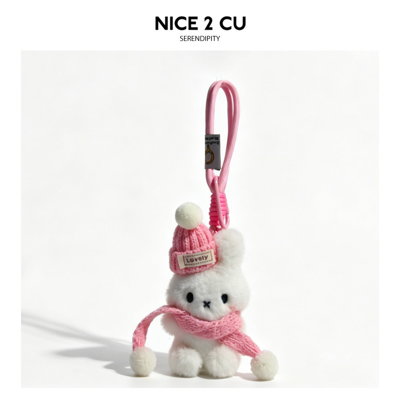 White plush rabbit charm with a pink knitted beanie, white pom-pom, and pink scarf on a pink hanging loop
