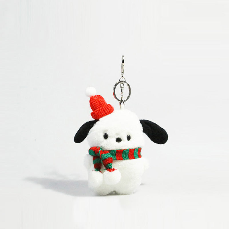 White plush dog keychain charm with black ears wearing a red Santa hat and red-and-green striped scarf