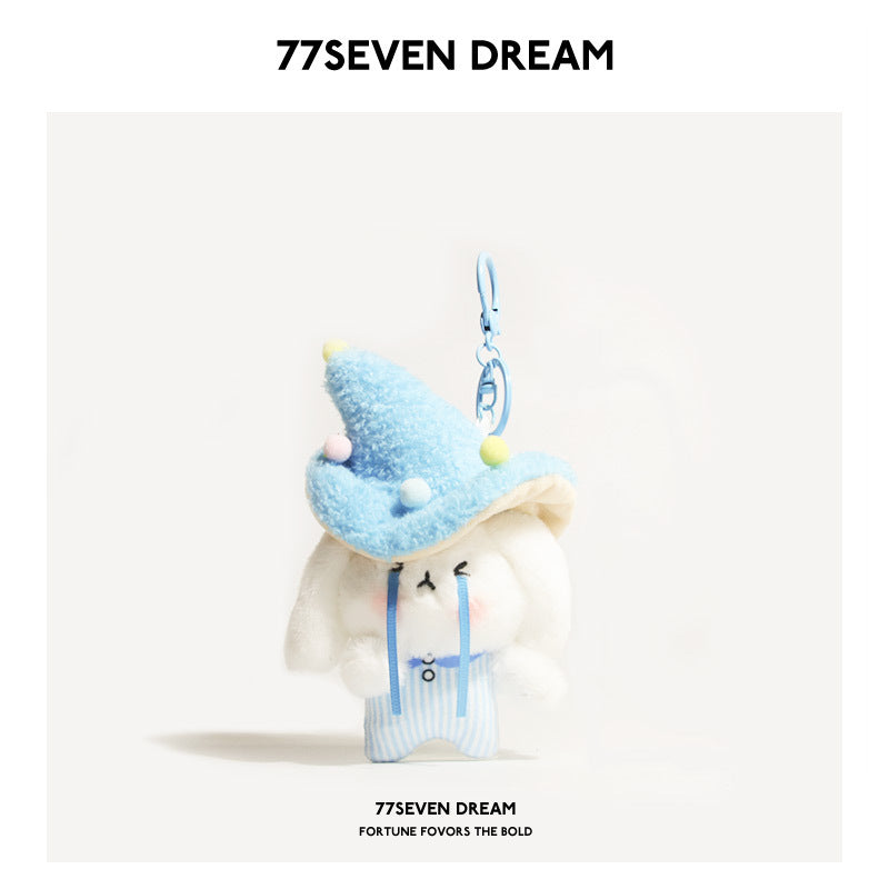 White rabbit plush keychain charm wearing a blue mushroom hat with pom-pom dots and blue striped outfit, metal keyring hardwa