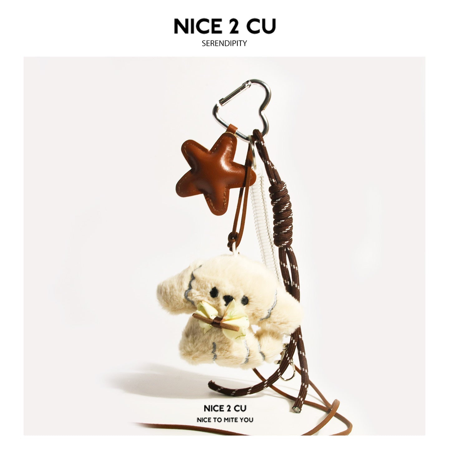 Cream plush dog charm with brown bow, brown star charm, heart carabiner clip, and braided brown cord