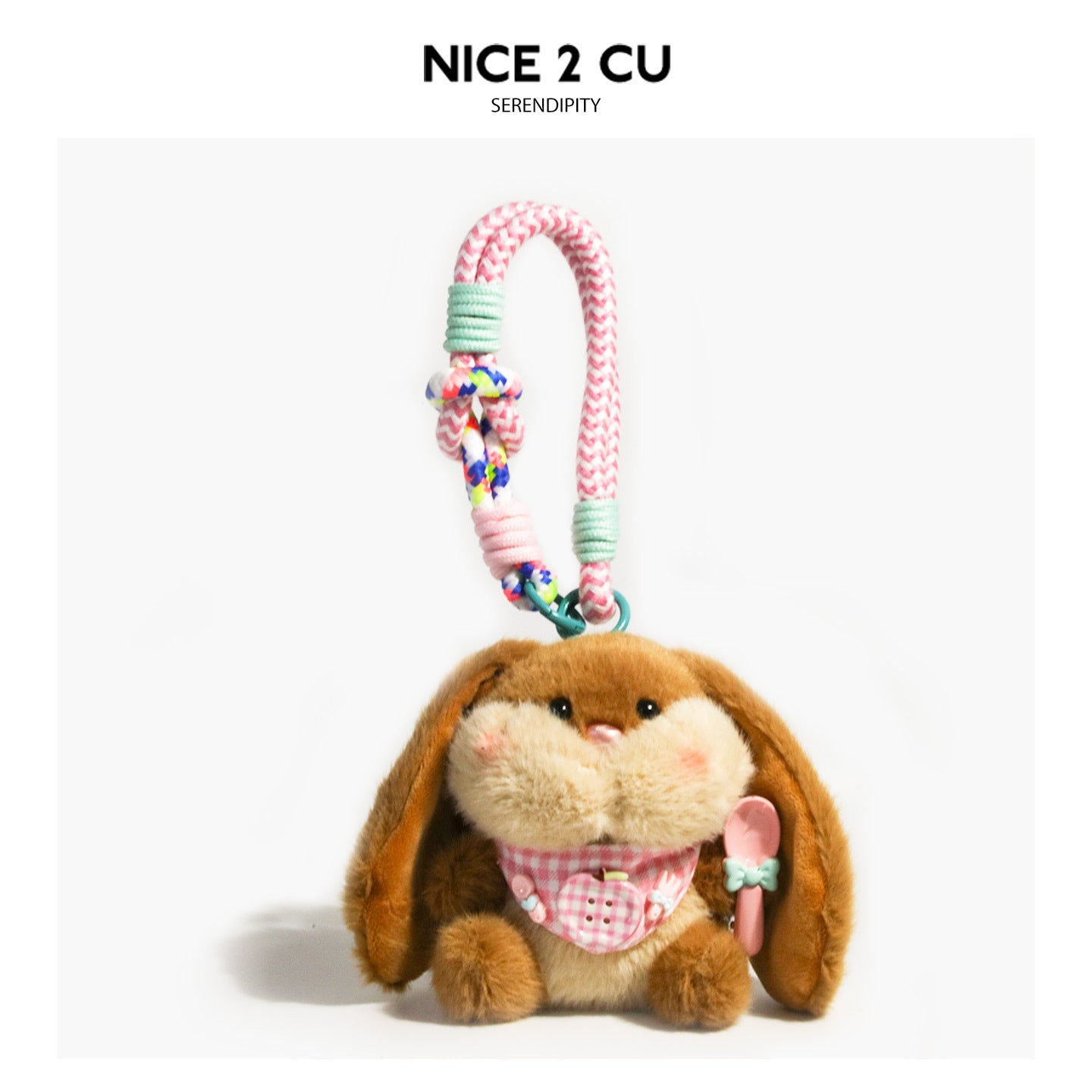 Dark brown floppy-ear bunny plush charm with yellow-cream face, pink gingham bib, and braided cord clip