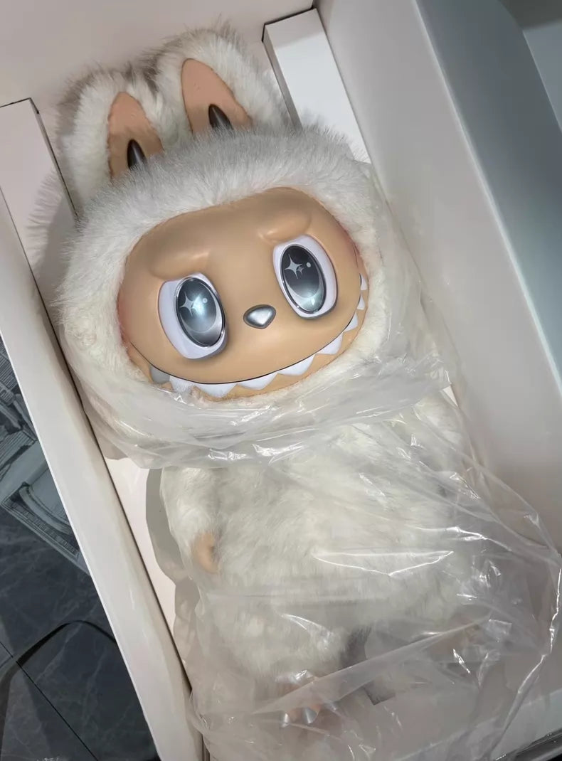 The POP MART Labubu Angel in Clouds 58cm Designer Plush Doll – THE MONSTERS Premium Limited Edition features big cartoon eyes, bunny ears, and a fluffy white suit, partially wrapped in plastic and presented in a sleek white box.