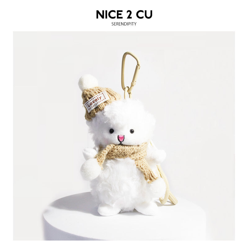 White fluffy lamb plush keychain wearing a khaki knit hat with pom-pom and matching knit scarf, gold carabiner clip