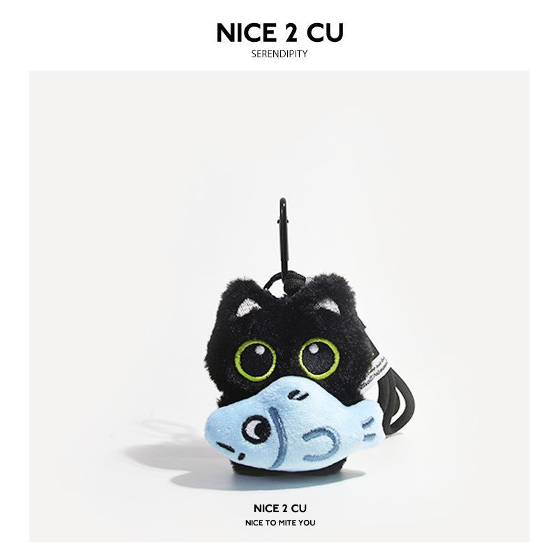 Black cat plush keychain holding a light blue fish-shaped accessory with carabiner clip