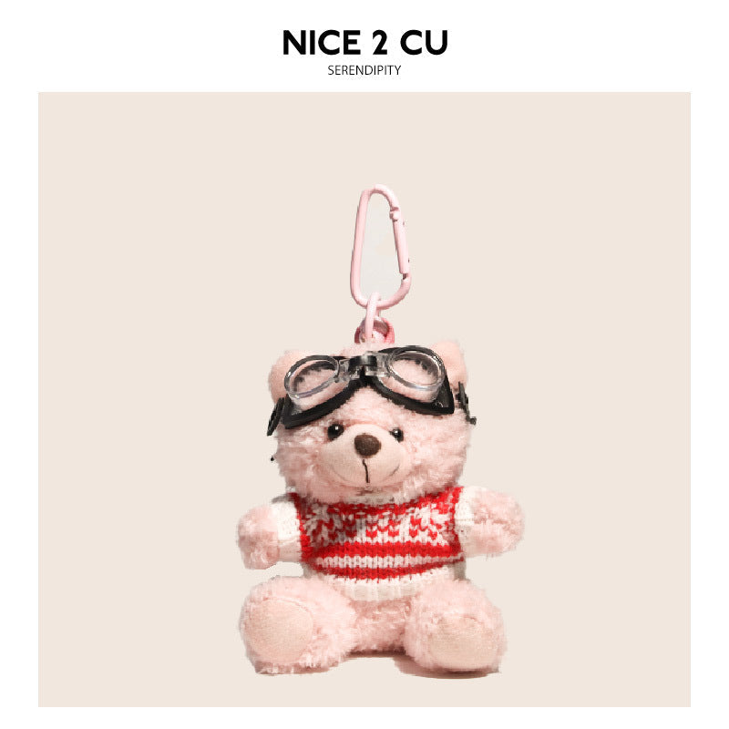 Pink teddy bear plush charm wearing a red-and-white striped knitted sweater and black aviator goggles