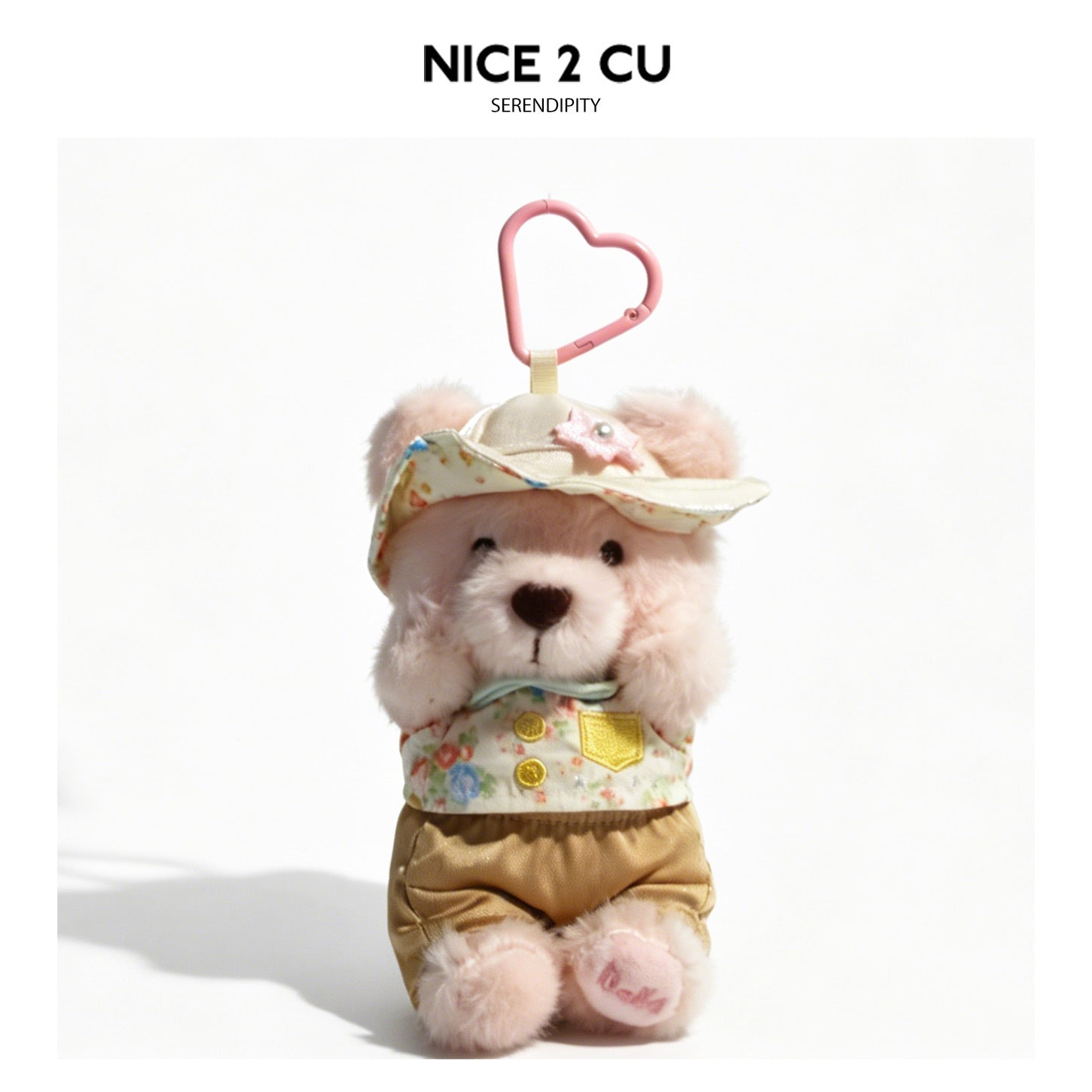 Plush teddy bear charm in floral outfit with paws near face and pink heart-shaped swivel clip